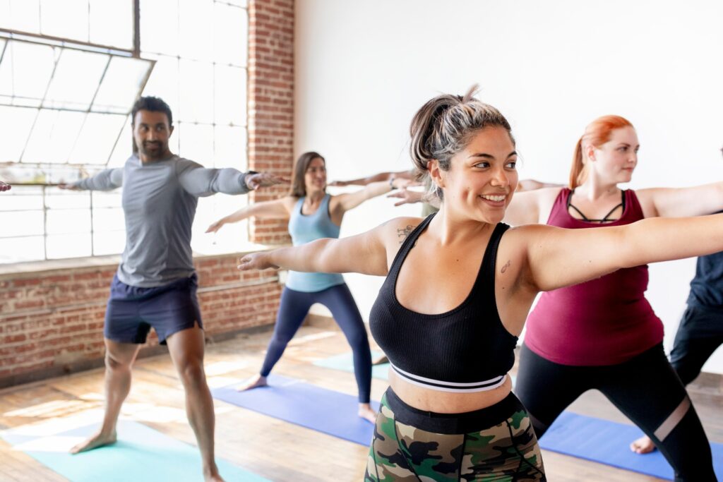 Photo of men and women in a yoga class