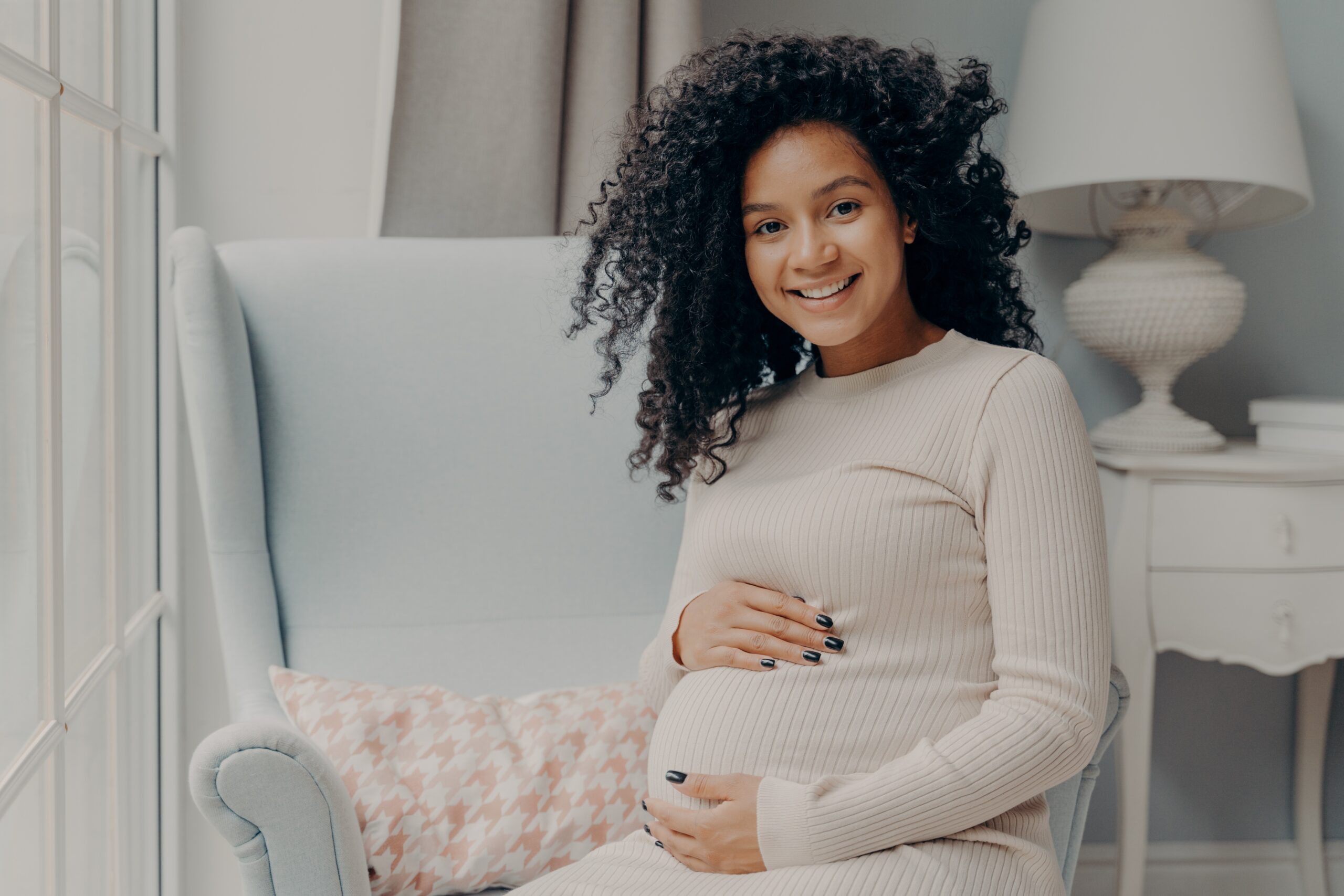 Image of Black pregnant woman, smiling